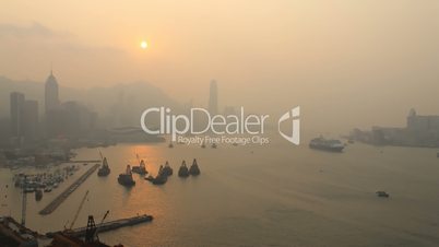 Time Lapse Sunset over Hong Kong Island Skyline with Harbor View. Misty.