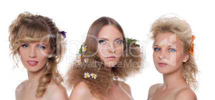 Three young naked women with flower hair style