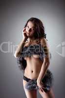 Nude woman in black panties posing with fur coat