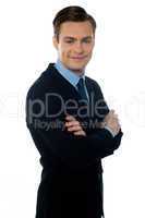 Charming young businessman posing in style