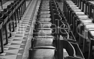 Rows of chairs inside Cathedral, monochrome