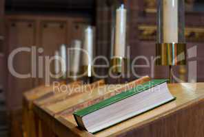 Bible on wooden bench in church