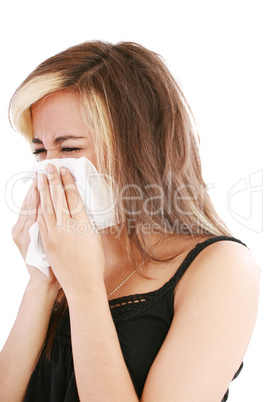 Closeup of gorgeous caucasian woman with cold sneezing into tiss