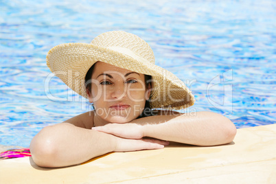 young beautiful woman at the pool in summer