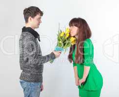 happy young couple with bouquet flowers