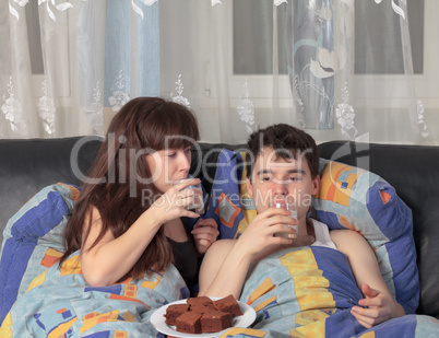 Young couple has breakfast in bed