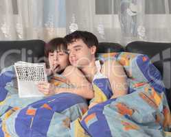 Young couple solving a crossword puzzle