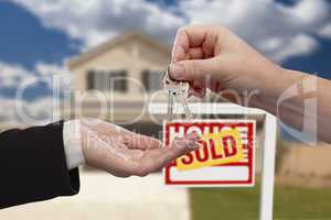 Handing Over the House Keys in Front of Sold New Home