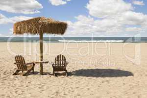 Two Beach Chairs and Umbrella on Beautiful Ocean Sand