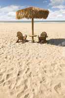 Two Beach Chairs and Umbrella on Beautiful Ocean Sand