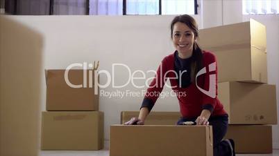 Happy woman smiling at home during move with boxes