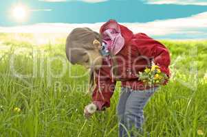 Little girl collect yellow flowers