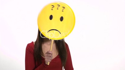 Confused young woman using emoticon for emotions