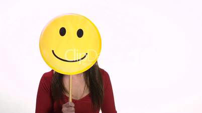 Happy young woman using smiling emoticon for emotions