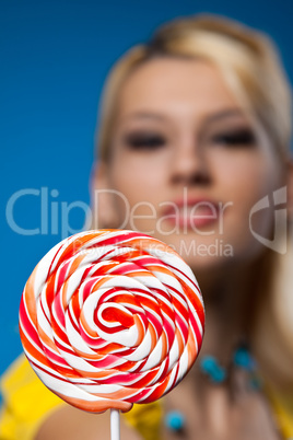 big lollipop and blond woman at background