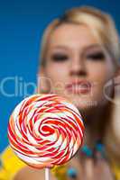 big lollipop and blond woman at background