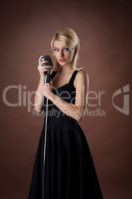 woman pin-up portrait in black with microphone