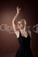 Pretty young woman posing on brown background