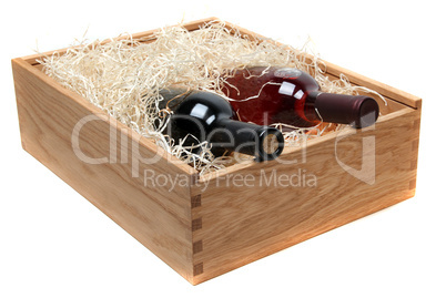 two wine bottles in wooden case with wood-wool on white