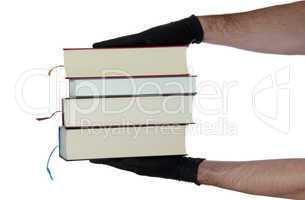 stack of books in hands with black gloves
