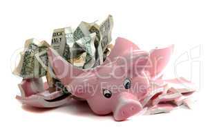 broken piggybank with dollar notes