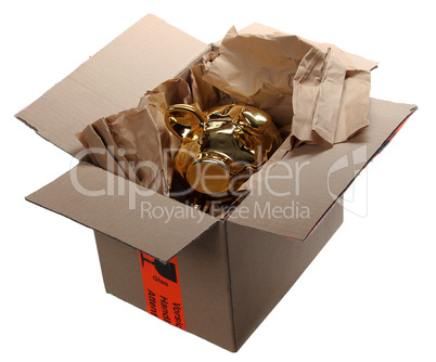 golden piggybank in cardboard box with brown paper