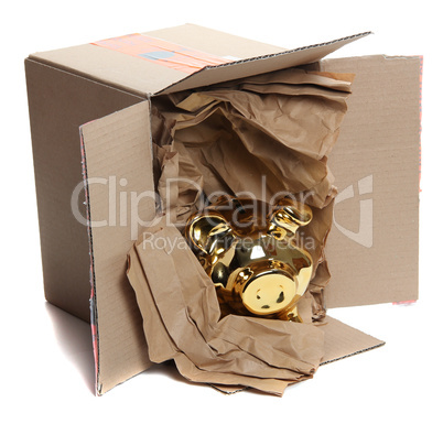 cardboard box with brown paper and golden piggybank