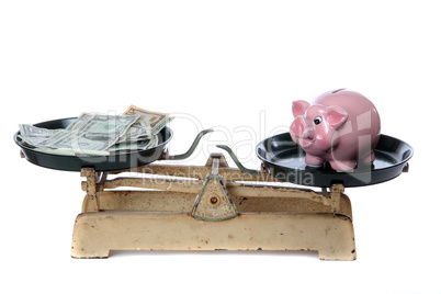 piggy bank and dollars on scale