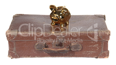 old brown suitcase with golden piggy bank