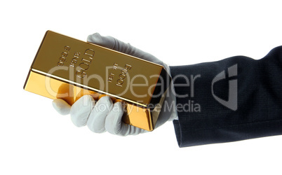 hand with glove holding a gold bullion