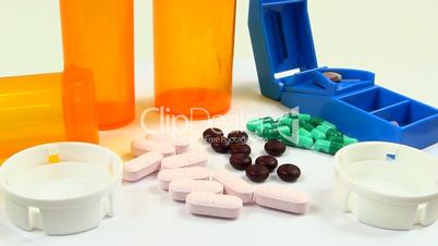 Drugs and Medicine; capsules, pills, tablets and splitter rotate clockwise
