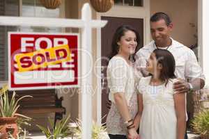 Hispanic Family in Front of Home with Sold Real Estate Sign