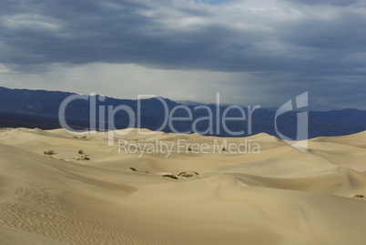 Wide dunes and cloudy mountain ranges, Death Valley, California