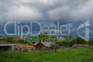 Old houses and dark clouds in Bannack, Montana