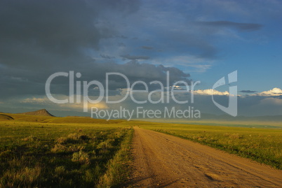 Gravel road, grasslands and mountains near Dillon, Montana