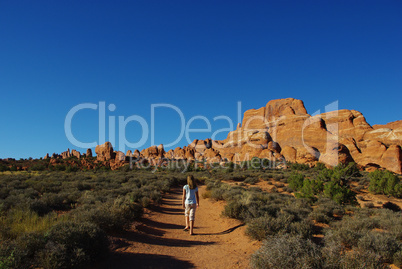 Walking on trail to rock formations in Arches National Park, Utah