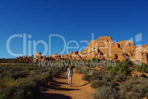 Walking on trail to rock formations in Arches National Park, Utah