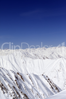 Snowy mountains and blue sky. Caucasus Mountains, Georgia.