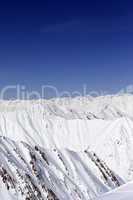 Snowy mountains and blue sky. Caucasus Mountains, Georgia.