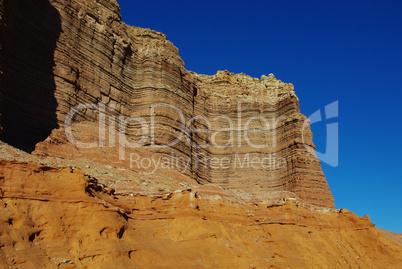 Orange and brown rock walls and formations with deep-blue sky, Glen Canyon National Recreation Area, Utah