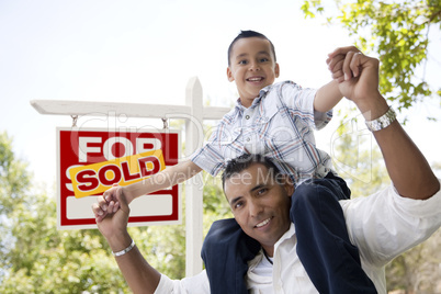 Hispanic Father and Son with Sold Real Estate Sign