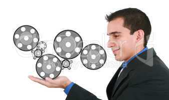 Businessman holding some mechanisms in his hands