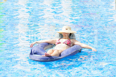 woman resting and tanning in the pool