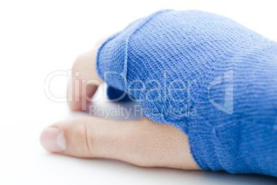 Hand bandaged in blue plaster