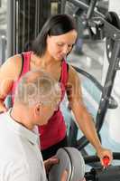 Fitness trainer adjust machine active man exercise