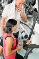 Fitness trainer adjust machine active man exercise