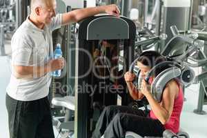 Two people at fitness center exercise abdominal