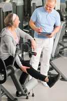 Physiotherapist assist active senior woman at gym