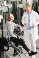 Physiotherapist assist active senior woman at gym