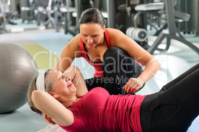 Senior woman exercise abdominal in fitness center